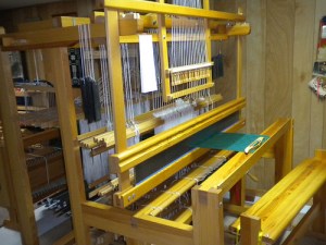 Loom threaded with damask, using drawloom shafts.